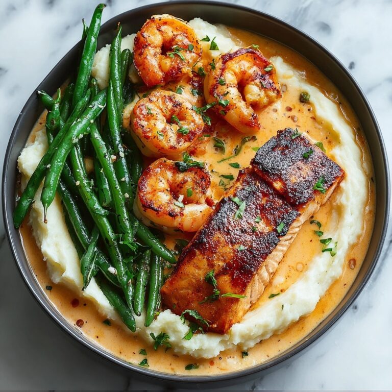Cajun Shrimp and Salmon with Garlic Cream Sauce, Mashed Potatoes, and Green Beans Recipe